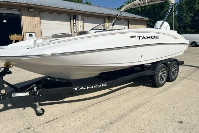 The Image of 2026 Tahoe 2150 boat on trailer, parked outdoors near a building. - 0