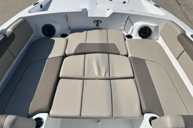 Slide: The Image of 2026 Tahoe 2150 boat interior with beige cushioned seating and built-in speakers. - 3