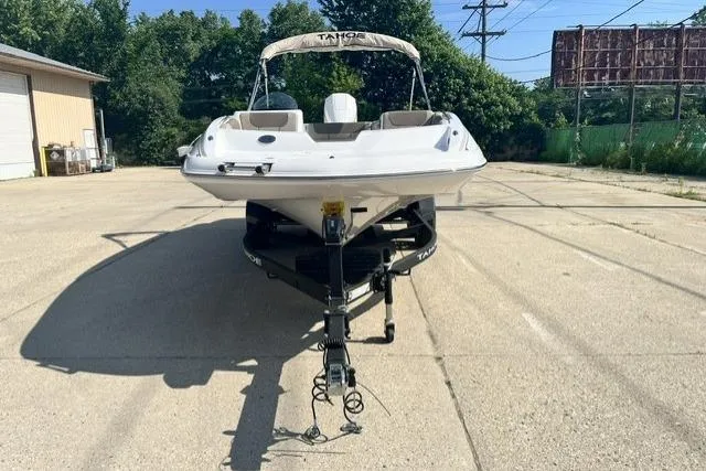 Slide: The Image of 2026 Tahoe 2150 boat on trailer in sunny outdoor setting. - 4
