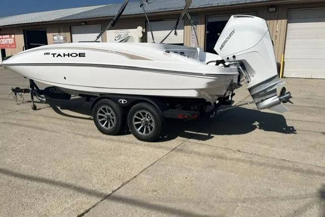 Slide: The Image of 2026 Tahoe 2150 boat on trailer with Mercury outboard engine, parked outdoors. - 5