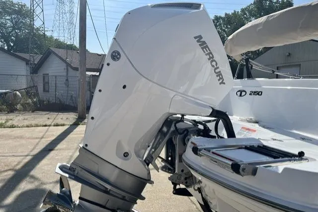 Slide: The Image of 2026 Tahoe 2150 boat with Mercury outboard motor in a sunny outdoor setting. - 7