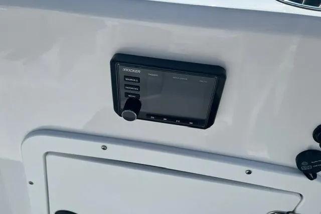 Slide: The Image of Control panel on a 2026 Tahoe 2150 boat dashboard, featuring a Kicker audio system. - 8