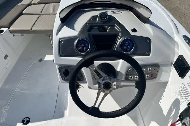 Slide: The Image of Steering console of a 2026 Tahoe 2150 boat with modern controls and gauges. - 9