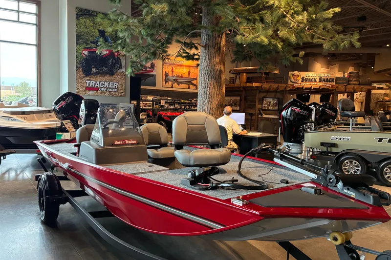 The Image of 2026 Tracker Bass Tracker Classic XL boat displayed in a showroom with outdoor-themed decor. - 0