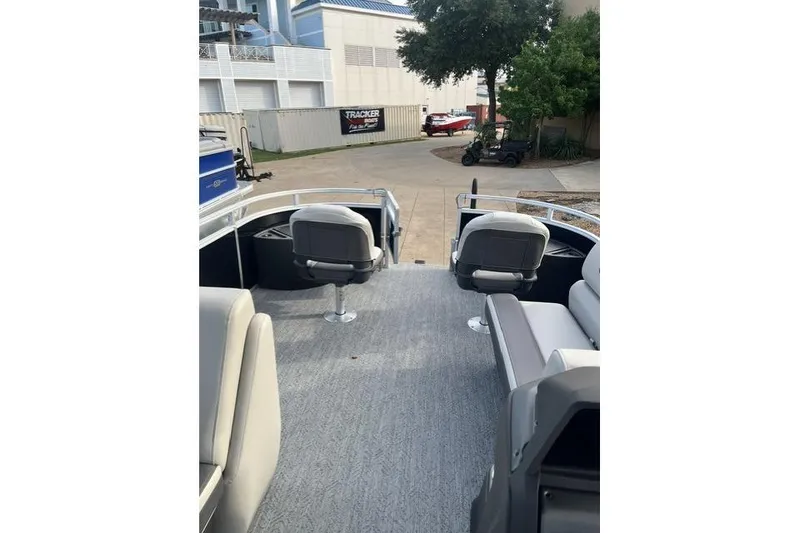 Slide: The Image of 2026 Sun Tracker Fishin' Barge 20 DLX interior with seating and fishing setup. - 10
