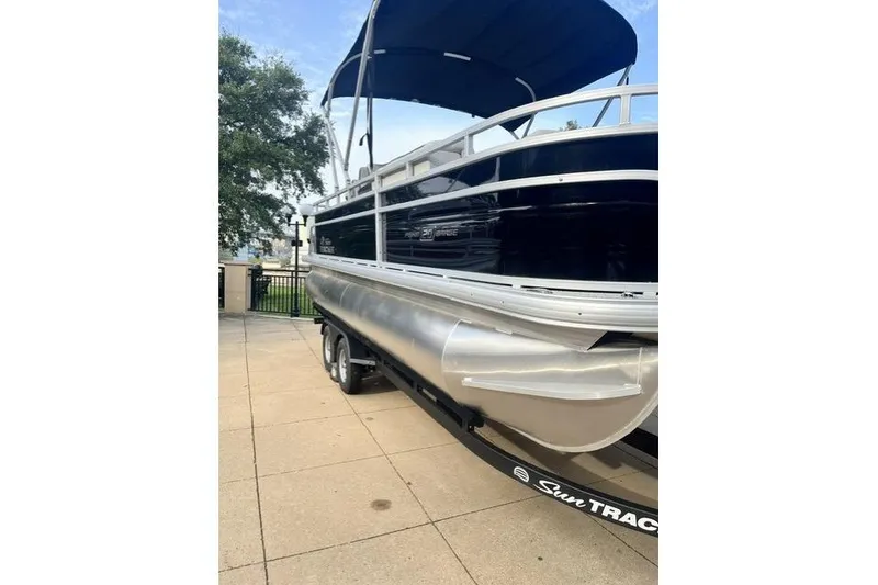 Slide: The Image of 2026 Sun Tracker Fishin' Barge 20 DLX pontoon boat with canopy on trailer. - 4