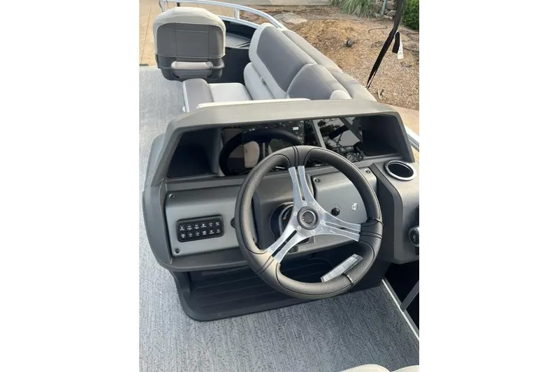 Slide: The Image of 2026 Sun Tracker Fishin' Barge 20 DLX steering console with modern design and controls. - 11