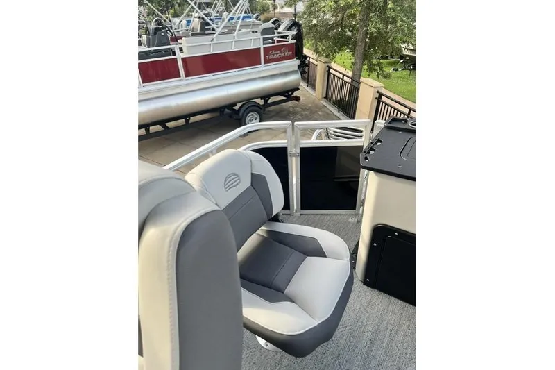 Slide: The Image of 2026 Sun Tracker Fishin' Barge 20 DLX interior with comfortable seating and sleek design. - 8