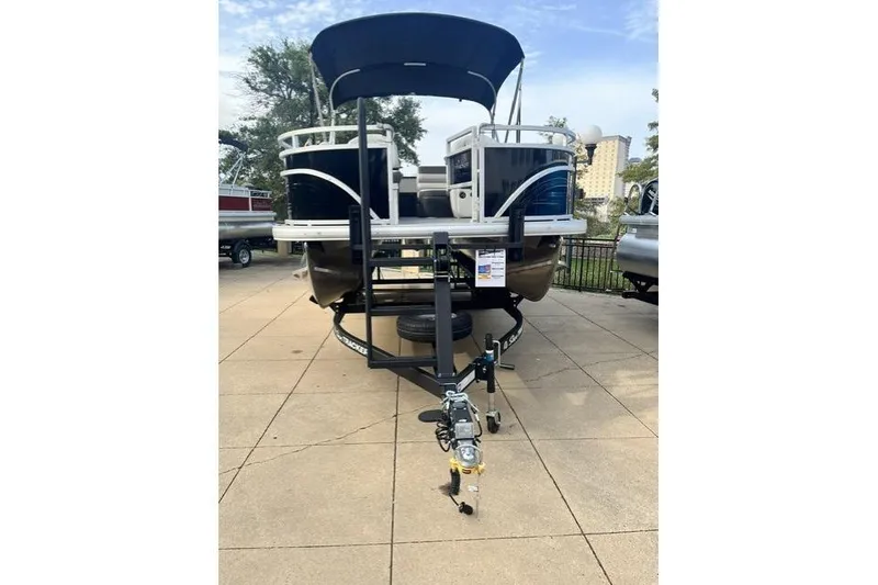 Slide: The Image of 2026 Sun Tracker Fishin' Barge 20 DLX pontoon boat on trailer, outdoor display. - 5