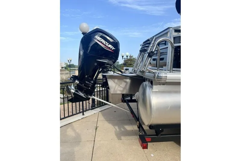 Slide: The Image of 2026 Sun Tracker Fishin' Barge 20 DLX with Mercury outboard motor on trailer. - 3