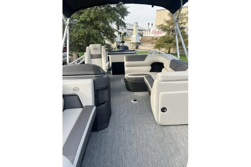 The Image of 2026 Sun Tracker Fishin' Barge 20 DLX interior with seating and canopy. - 0