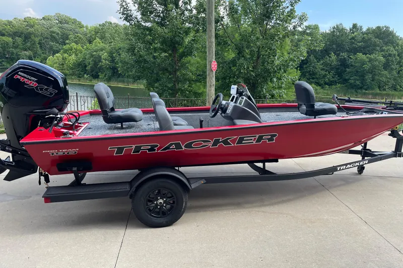 The Image of 2026 Tracker Pro Team 190 boat on trailer by a lake. - 0