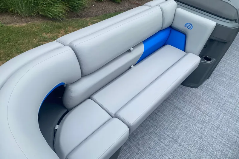 Slide: The Image of 2026 Sun Tracker Party Barge 20 DLX boat seating, featuring gray and blue upholstery. - 6