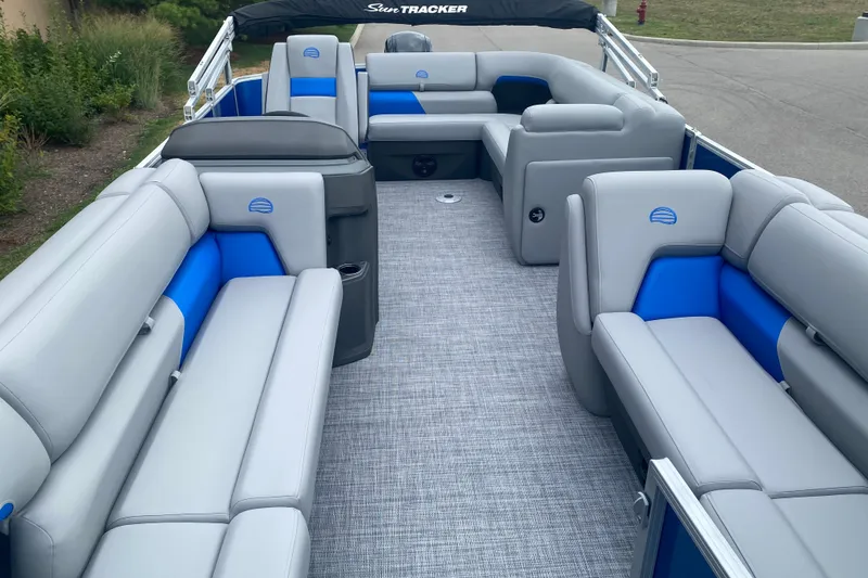 Slide: The Image of 2026 Sun Tracker Party Barge 20 DLX interior with gray and blue seating. - 8