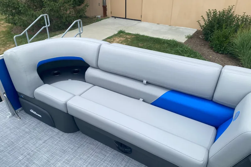 Slide: The Image of 2026 Sun Tracker Party Barge 20 DLX pontoon boat seating, featuring gray and blue upholstery. - 11