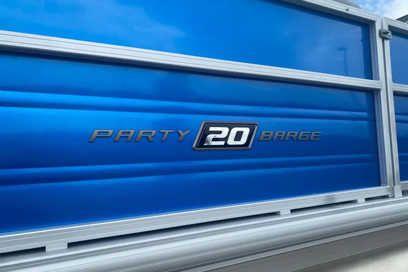 Slide: The Image of 2026 Sun Tracker Party Barge 20 DLX, blue exterior detail with logo. - 1