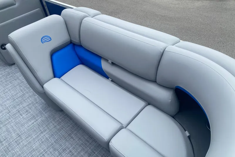 Slide: The Image of 2026 Sun Tracker Party Barge 20 DLX pontoon boat seating, featuring gray and blue upholstery. - 7