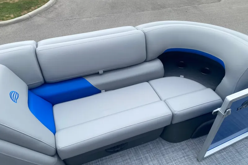 Slide: The Image of 2026 Sun Tracker Party Barge 20 DLX pontoon boat with gray and blue seating. - 12