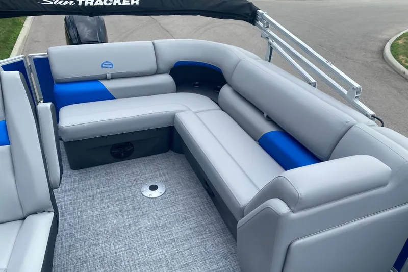 Slide: The Image of 2026 Sun Tracker Party Barge 20 DLX with gray and blue seating, spacious deck layout. - 9