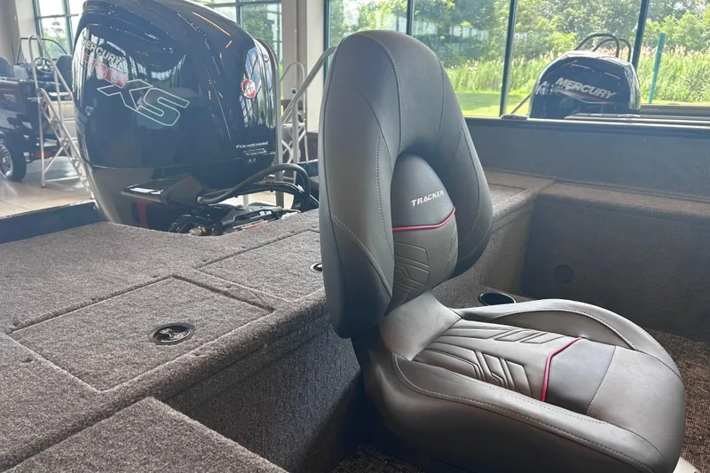 Slide: The Image of Interior of 2026 Tracker Pro Guide V-175 WT boat with Mercury engine in showroom. - 6