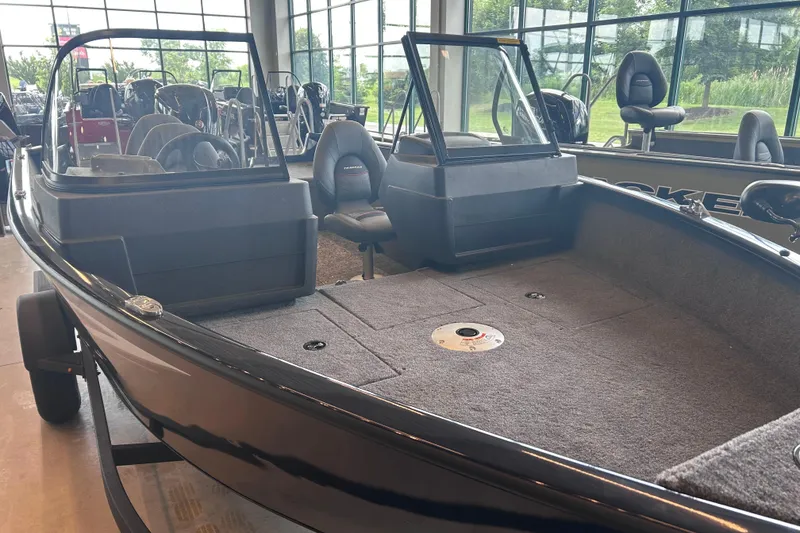 Slide: The Image of 2026 Tracker Pro Guide V-175 WT boat interior with spacious seating and carpeted deck. - 2