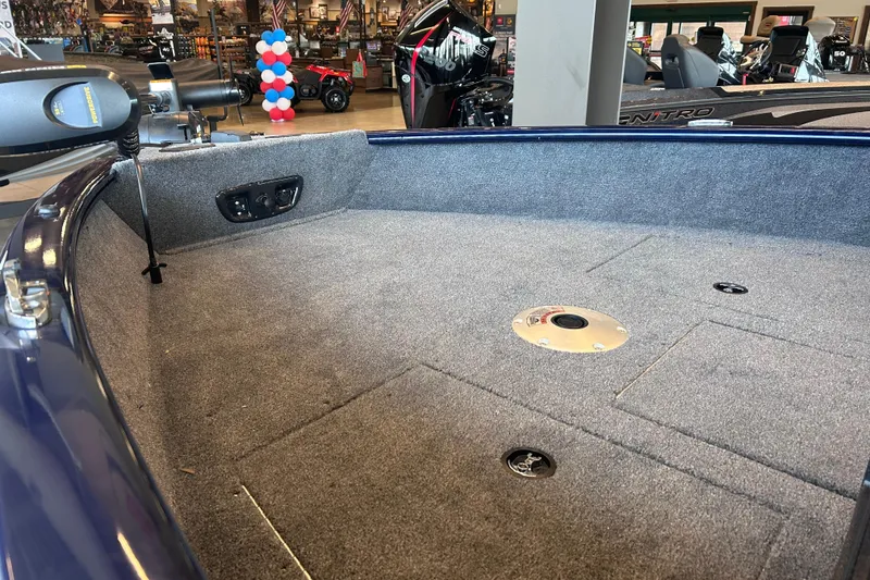 Slide: The Image of 2026 Tracker Pro Guide V-175 WT boat interior with carpeted deck and motor controls. - 14