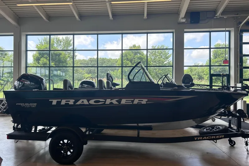The Image of 2026 Tracker Pro Guide V-175 WT boat in showroom, side view with trailer. - 0