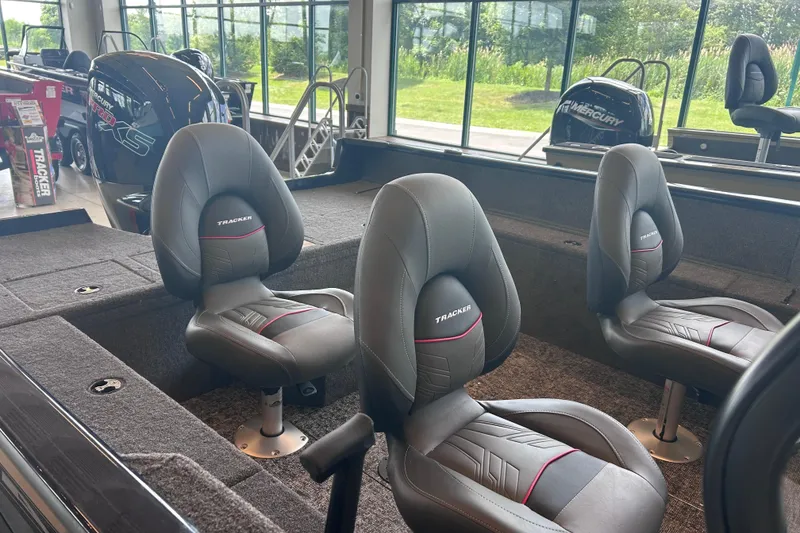 Slide: The Image of 2026 Tracker Pro Guide V-175 WT boat interior with cushioned seating and Mercury engine. - 4