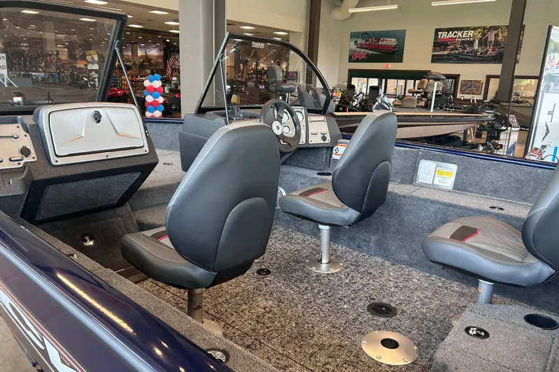 Slide: The Image of Interior of a 2026 Tracker Pro Guide V-175 WT boat with seating and dashboard. - 12