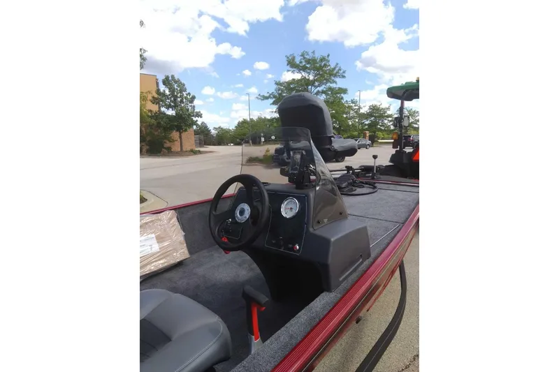 Slide: The Image of 2026 Tracker Bass Tracker Classic XL boat interior with steering wheel and dashboard. - 2