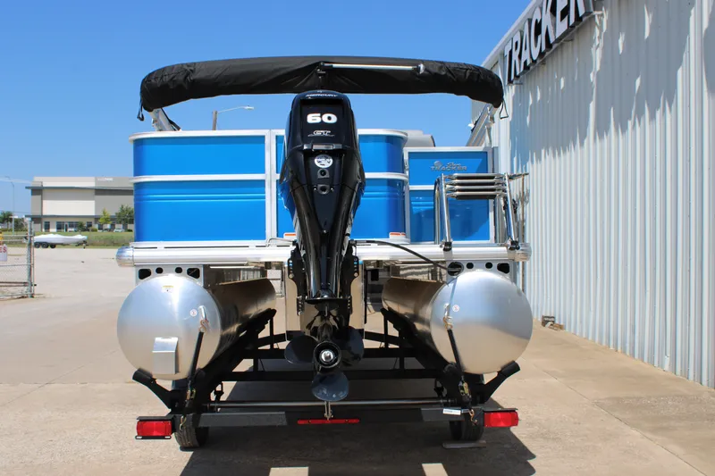 Slide: The Image of 2026 Sun Tracker Party Barge 18 DLX pontoon boat with 60 HP engine, parked outdoors. - 2