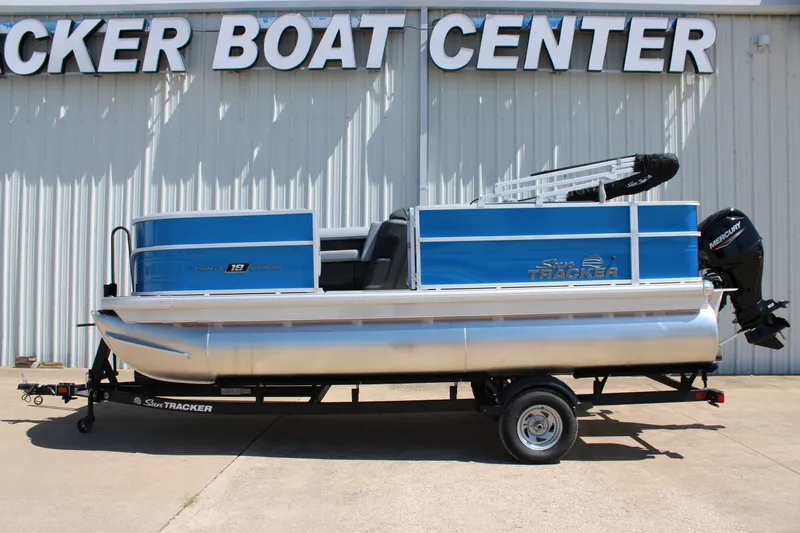 Slide: The Image of 2026 Sun Tracker Party Barge 18 DLX pontoon boat on trailer at dealership. - 5