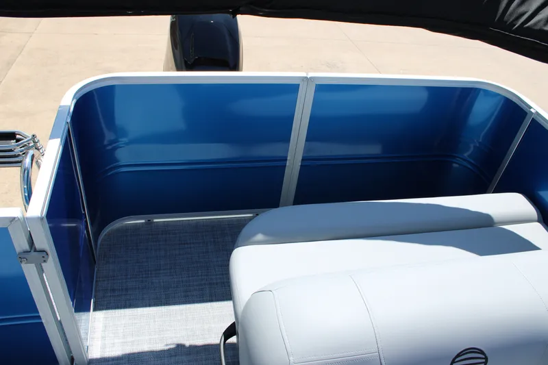 Slide: The Image of 2026 Sun Tracker Party Barge 18 DLX interior with blue panels and cushioned seating. - 12
