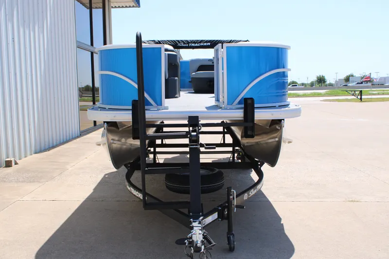 Slide: The Image of 2026 Sun Tracker Party Barge 18 DLX pontoon boat on trailer, parked outdoors. - 6