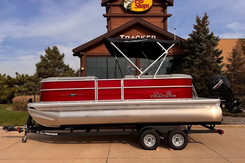 The Image of 2026 Sun Tracker Party Barge 20 DLX pontoon boat on trailer, parked outside Pro Shop. - 0