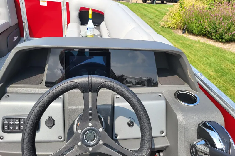 Slide: The Image of 2026 Sun Tracker Party Barge 20 DLX dashboard with steering wheel and control panel. - 10