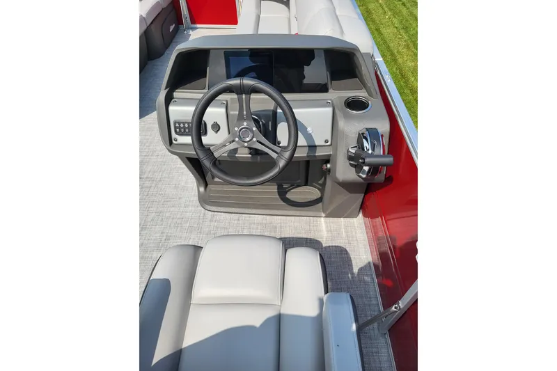 Slide: The Image of 2026 Sun Tracker Party Barge 20 DLX helm with steering wheel and controls. - 3