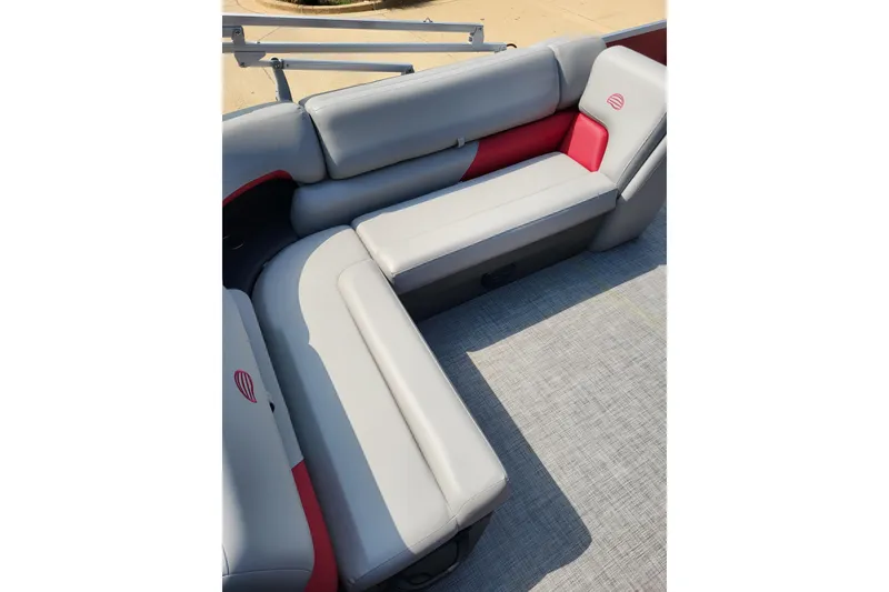 Slide: The Image of 2026 Sun Tracker Party Barge 20 DLX interior seating with gray and red upholstery. - 4