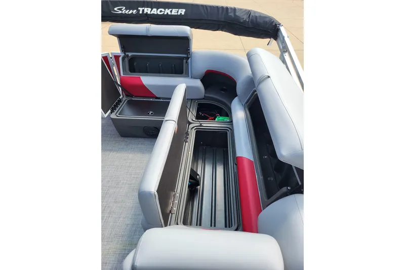 Slide: The Image of 2026 Sun Tracker Party Barge 20 DLX interior with open storage compartments. - 5