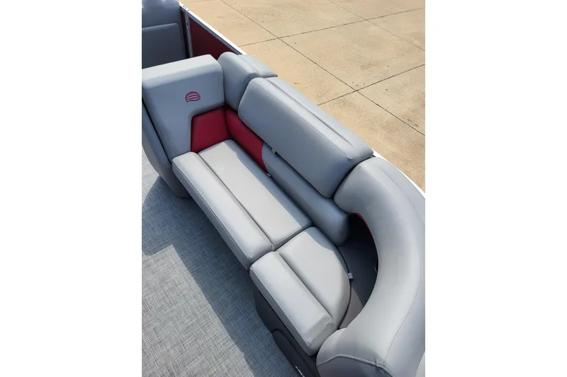 Slide: The Image of 2026 Sun Tracker Party Barge 20 DLX, featuring luxurious gray seating with red accents. - 8