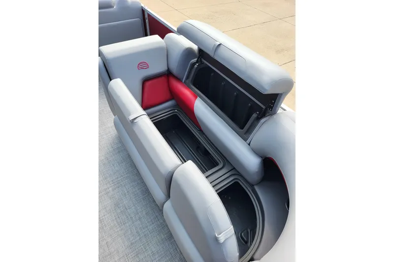 Slide: The Image of 2026 Sun Tracker Party Barge 20 DLX interior with open storage compartments. - 9