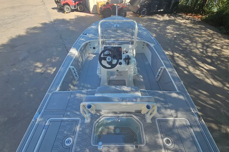 Slide: The Image of 2026 Mako 18 Pro Skiff boat, top view, parked outdoors, showcasing interior layout. - 7