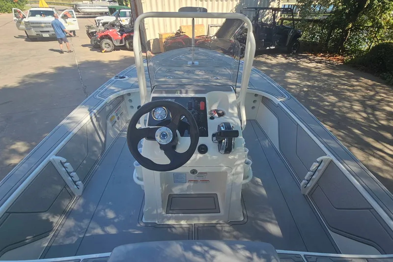 Slide: The Image of 2026 Mako 18 Pro Skiff boat interior with steering wheel and control panel. - 8