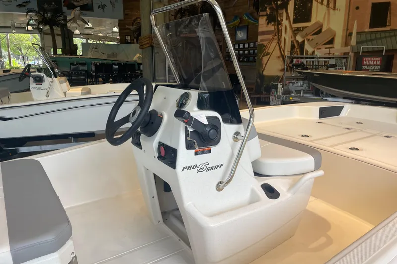 Slide: The Image of 2026 Mako Pro Skiff 15 CC boat interior with steering console and seating. - 3