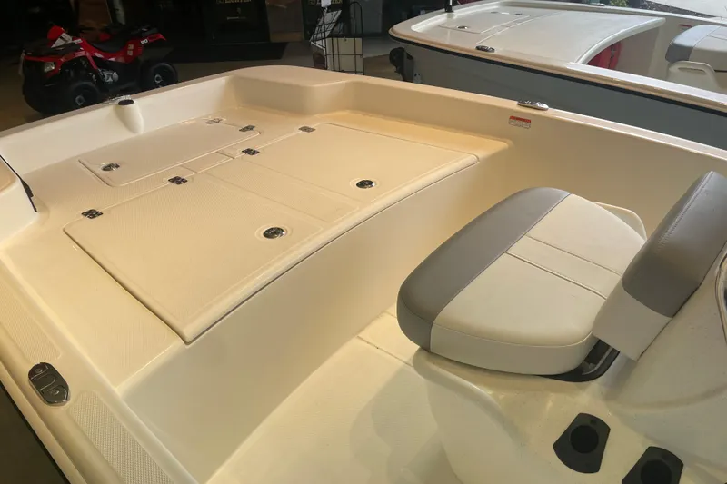Slide: The Image of 2026 Mako Pro Skiff 15 CC boat interior with seating and storage compartments. - 6