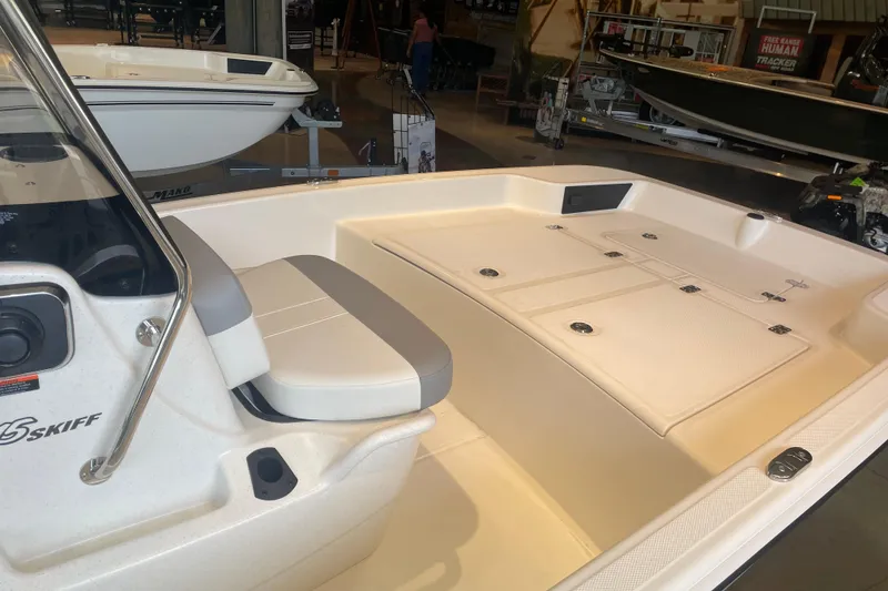 Slide: The Image of 2026 Mako Pro Skiff 15 CC boat interior with seating and storage compartments. - 4