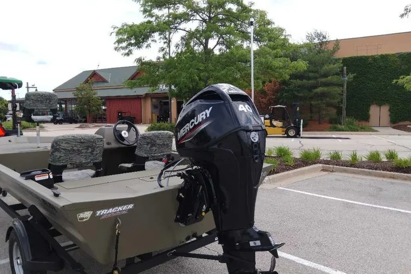 Slide: The Image of Tracker Grizzly 1754 SC with Mercury 40 HP engine on a trailer in a parking lot. - 4