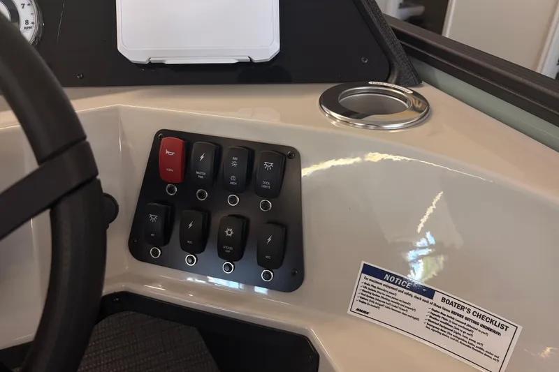 Slide: The Image of Control panel of 2026 Crest Conquest 230 SLSC boat with switches and checklist. - 15