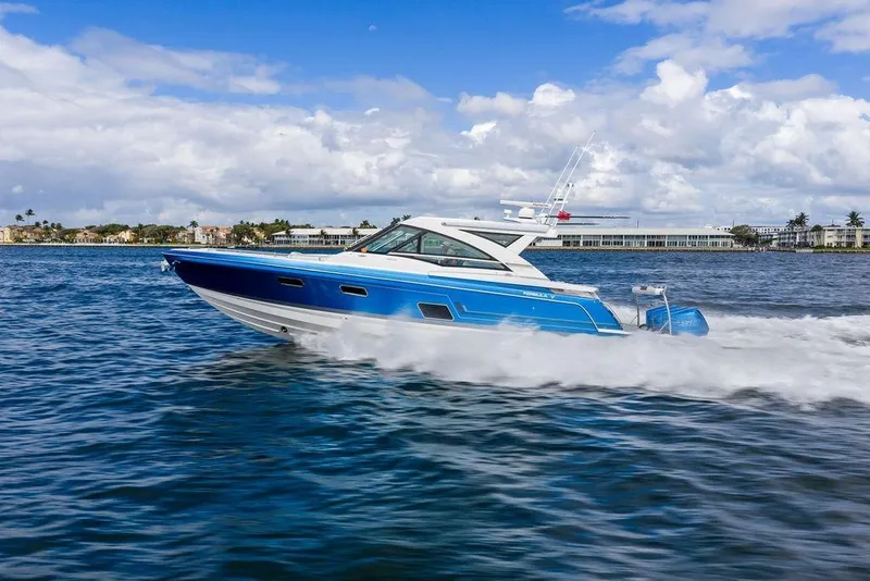 Slide: The Image of 2023 Formula 430 Super Sport Crossover cruising on open water under a cloudy sky. - 10