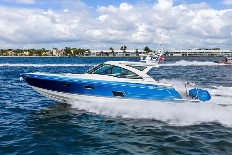 Slide: The Image of 2023 Formula 430 Super Sport Crossover cruising on open water under a cloudy sky. - 11